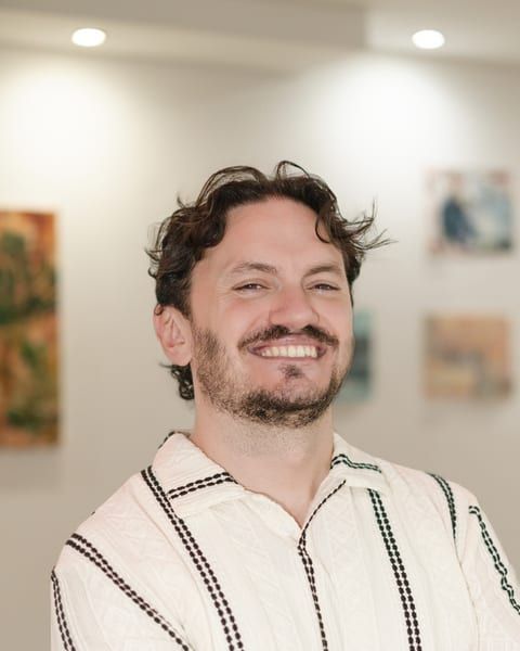 Damien Mulhall, Co-Founder, Strategy and Content. Striped shirt.