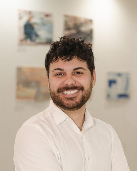 Roger Junior, Co-Founder, Product and Engineering. White shirt.